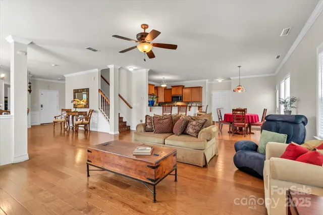 a living room with furniture and kitchen view