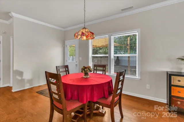 a dining room with furniture a chandelier and window