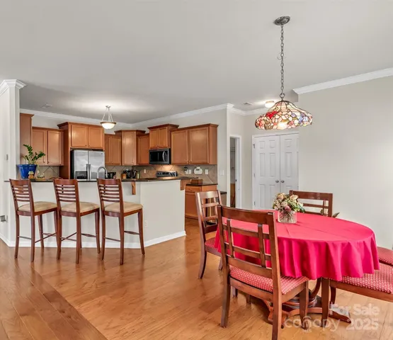 a view of a dining room with furniture and chandelier