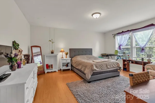 a bedroom with a bed couch and a window