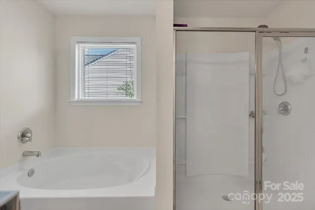 a white bath tub sitting next to a shower