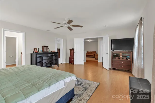 a bed room with a bed and a television