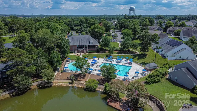 an aerial view of a house with a garden and lake view