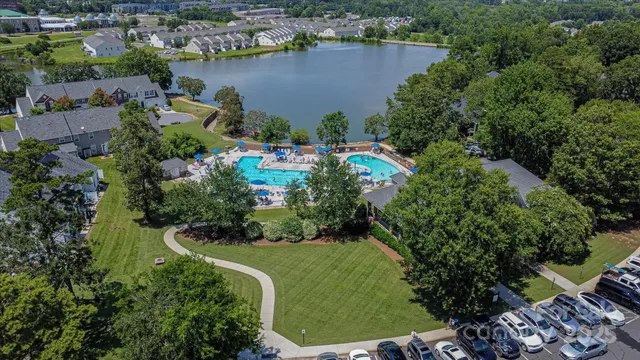 an aerial view of a house with a yard and lake view