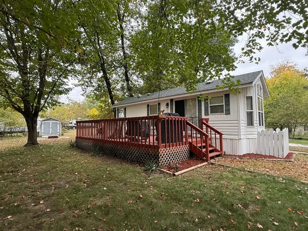 a view of a house with a yard and deck