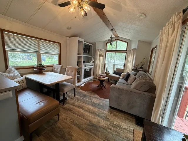 a living room with furniture fireplace and a large window