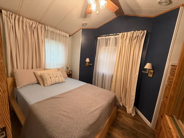 a bedroom with a bed and a mirror