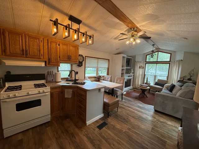 a kitchen with cabinets a stove and a wooden floor