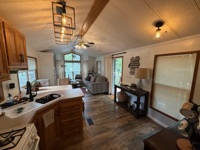 a view of a livingroom with furniture and a ceiling fan
