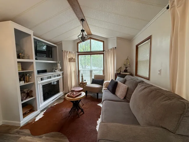 a living room with furniture fireplace and flat screen tv