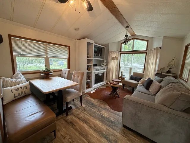 a living room with furniture a window and a flat screen tv