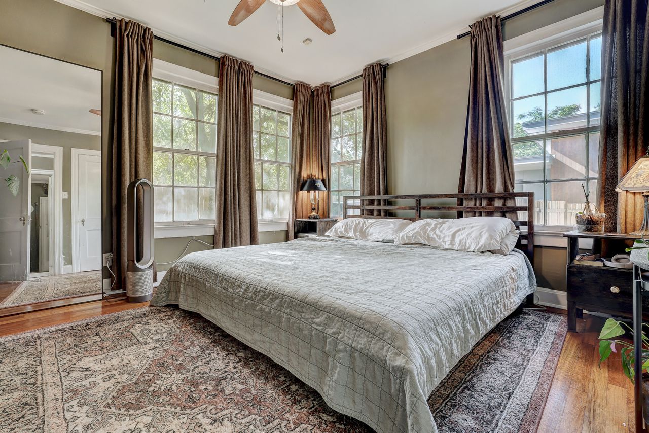 809 East 44th Street Austin, TX 78751 - Photo 22 of 37 Bedroom featuring crown molding, wood finished floors, multiple windows, and ceiling fan