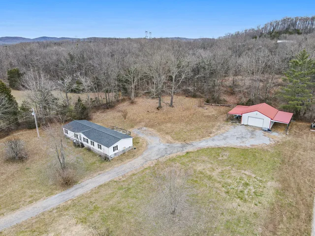 an aerial view of a house with an outdoor space