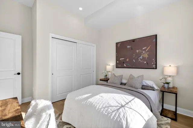 a bedroom with a bed and wooden floor