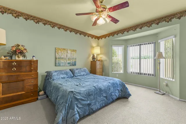 a bedroom with furniture and a flat screen tv