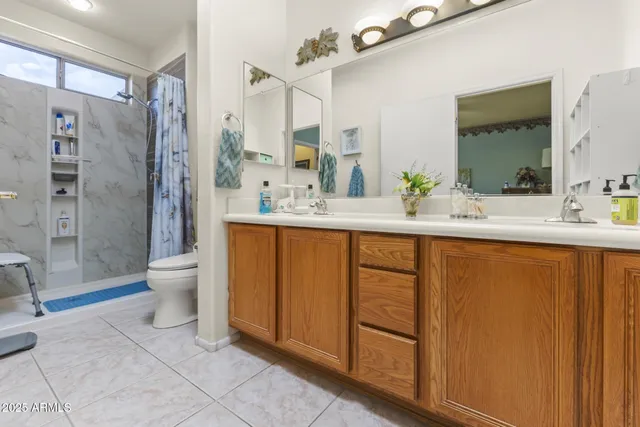 a view of a patio with table and chairs potted plants with wooden floor and fence