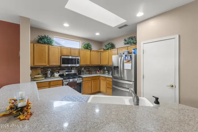 a kitchen with sink stove and view living room
