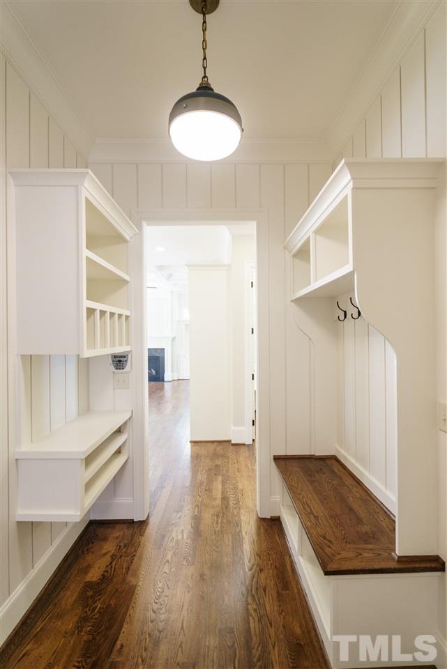 6120 Ponderosa Road Raleigh, NC 27612 - Photo 13 of 25 a view of a hallway with wooden floor and cabinet