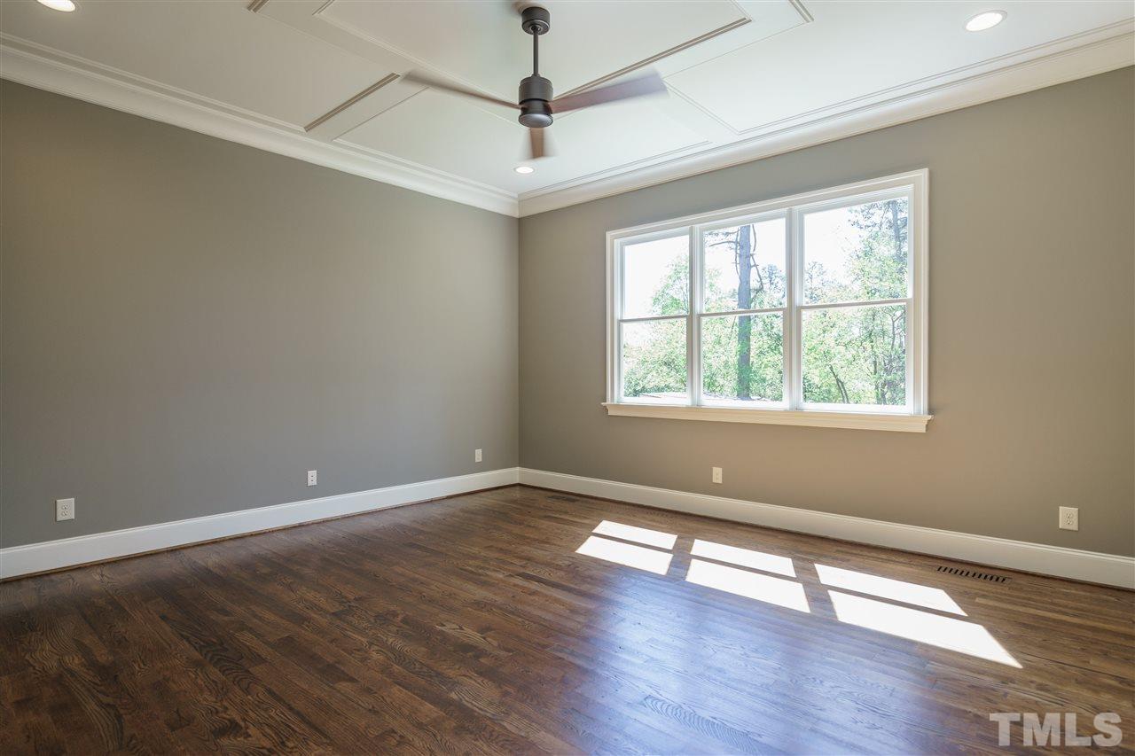6120 Ponderosa Road Raleigh, NC 27612 - Photo 14 of 25 a view of an empty room with wooden floor and a window
