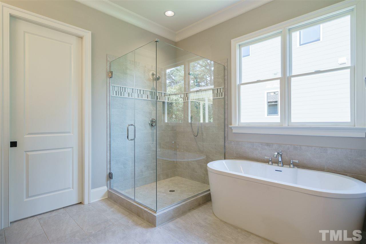 6120 Ponderosa Road Raleigh, NC 27612 - Photo 16 of 25 a bathroom with a bathtub and a shower