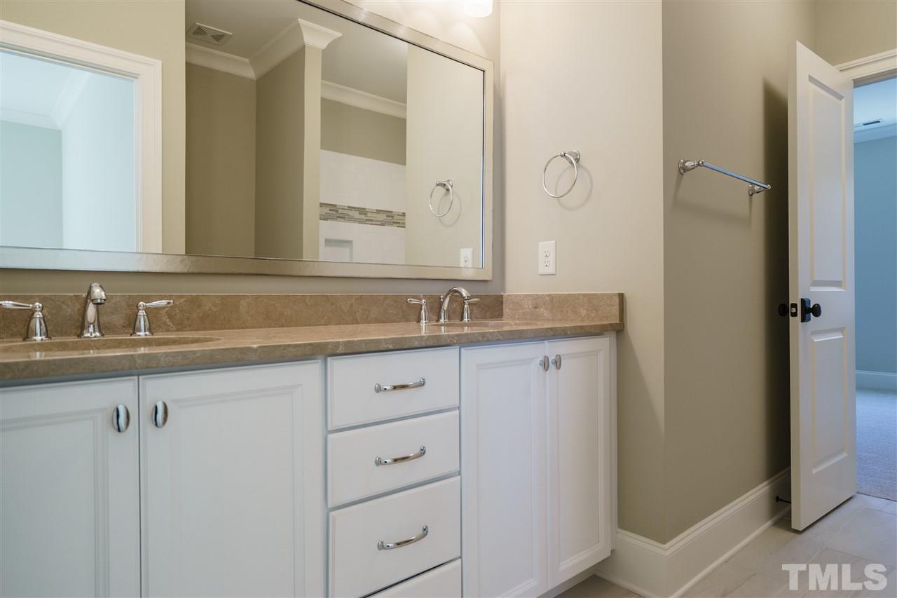 6120 Ponderosa Road Raleigh, NC 27612 - Photo 20 of 25 a bathroom with double sink and a mirror