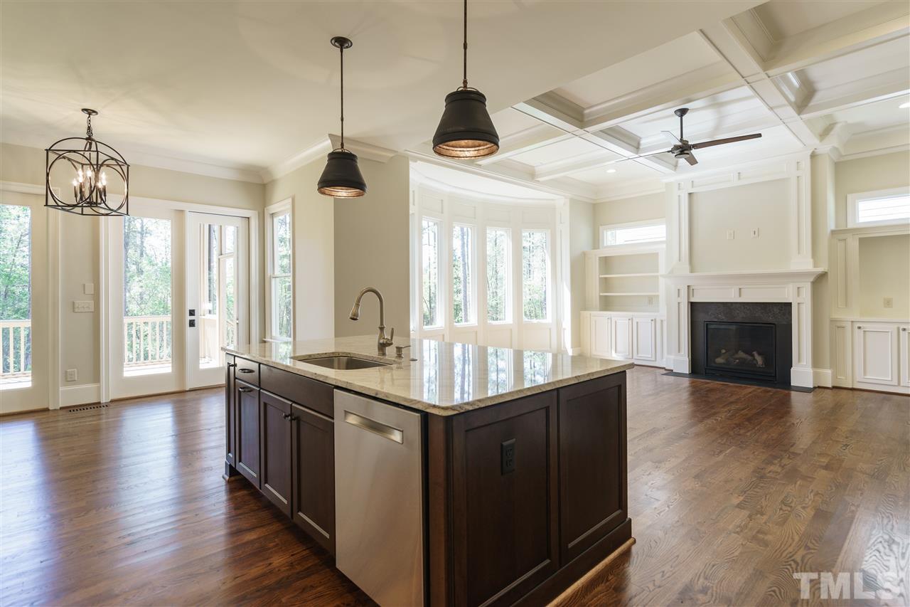 6120 Ponderosa Road Raleigh, NC 27612 - Photo 5 of 25 a kitchen with stainless steel appliances granite countertop a stove a sink and a wooden floors
