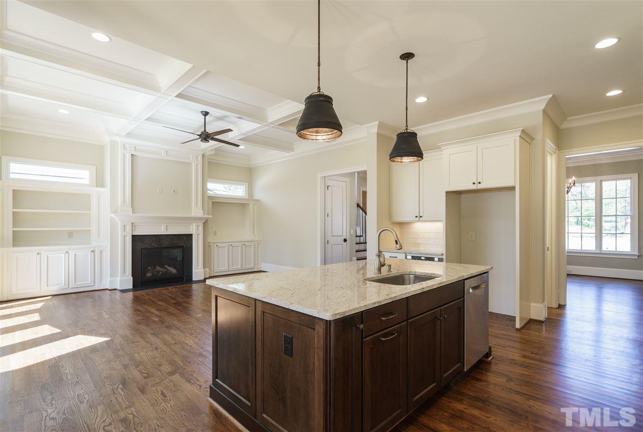 6120 Ponderosa Road Raleigh, NC 27612 - Photo 6 of 25 a kitchen with sink cabinets and wooden floor
