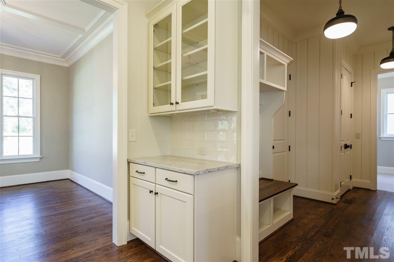 6120 Ponderosa Road Raleigh, NC 27612 - Photo 8 of 25 an entryway with wooden floor and cabinet
