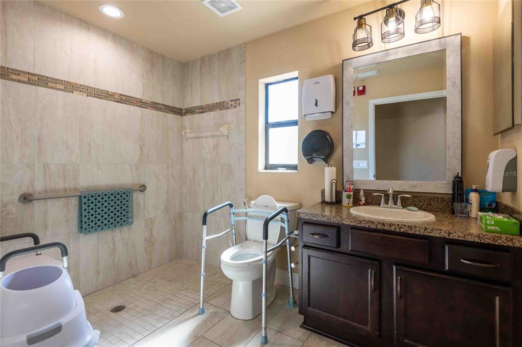Undisclosed Address Spring Hill, FL 34608 - Photo 15 of 39 a bathroom with a toilet a sink and mirror