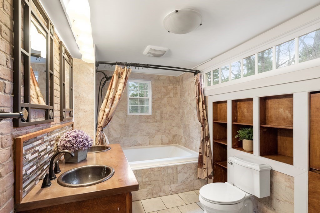 92 Goodnow Road Sudbury, MA 01776 - Photo 17 of 37 a bathroom with a sink a bathtub and a toilet