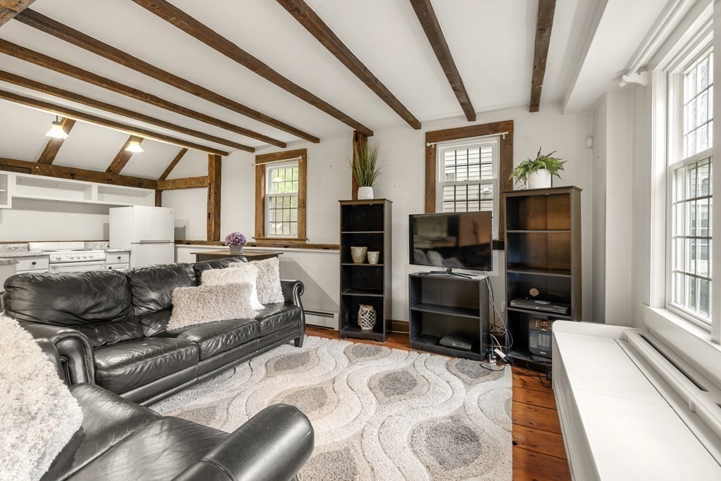 92 Goodnow Road Sudbury, MA 01776 - Photo 23 of 37 a living room with furniture and a flat screen tv