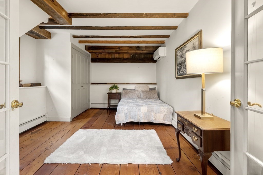92 Goodnow Road Sudbury, MA 01776 - Photo 24 of 37 a bedroom with a bed and wooden floor
