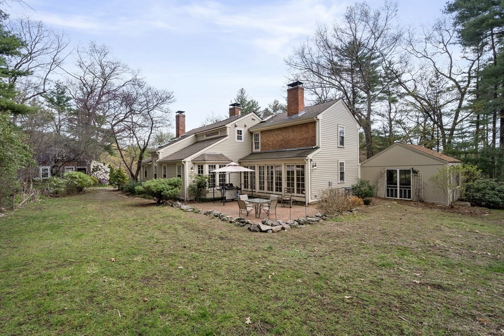 92 Goodnow Road Sudbury, MA 01776 - Photo 33 of 37 a white house that has a tree in front of it