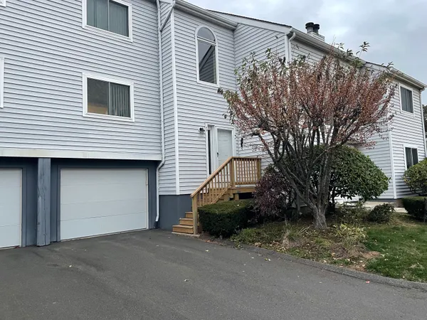 a view of a house with a backyard and garage