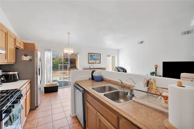 a kitchen that has a sink and a stove in it