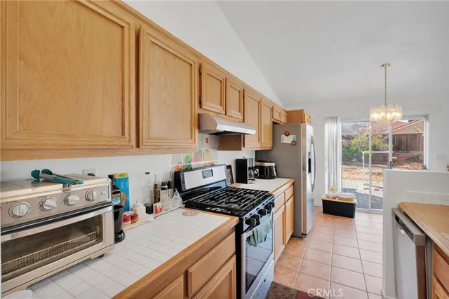 a kitchen with stainless steel appliances a stove a sink and a refrigerator