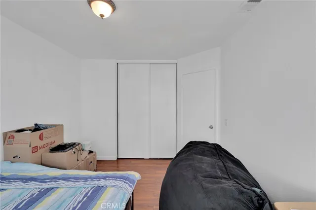 a bedroom with a bed and a painting on the wall