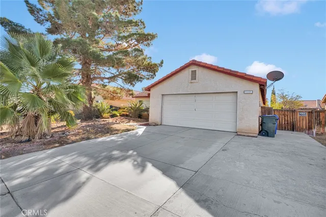 a view of garage and wooden fence