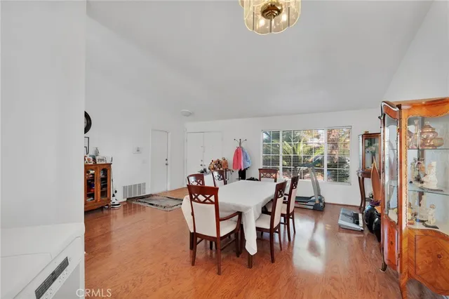 a dining room with furniture and a chandelier