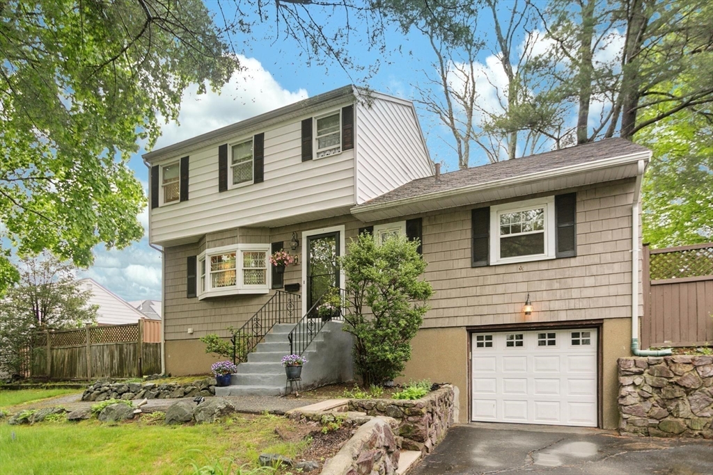 8 Dodge Street Arlington, MA 02474 - Photo 1 of 36 a front view of a house with a yard garage and tree