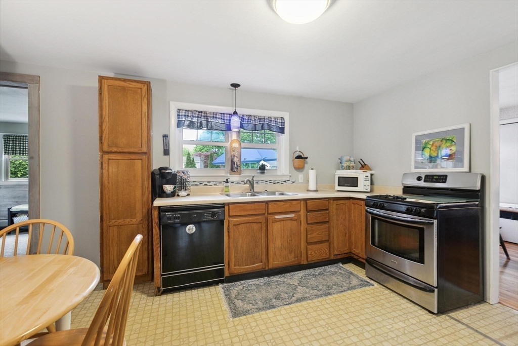 8 Dodge Street Arlington, MA 02474 - Photo 13 of 36 a kitchen with stainless steel appliances granite countertop a sink stove and refrigerator