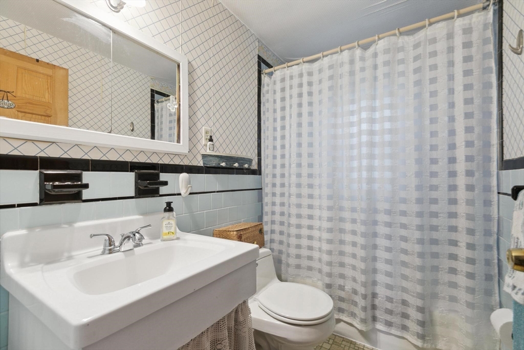 8 Dodge Street Arlington, MA 02474 - Photo 19 of 36 a bathroom with a sink a toilet and a mirror