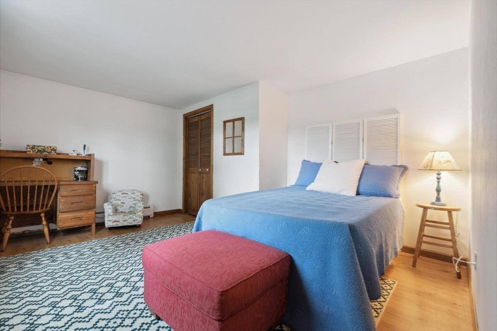 8 Dodge Street Arlington, MA 02474 - Photo 21 of 36 a bedroom with a bed and wooden floor