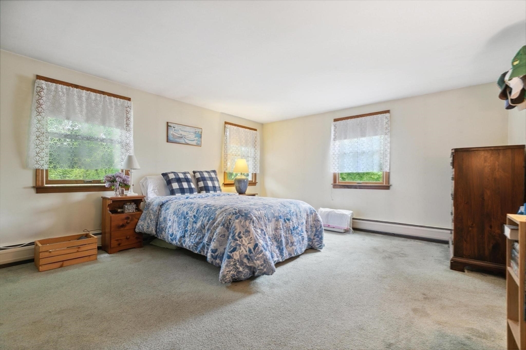 8 Dodge Street Arlington, MA 02474 - Photo 22 of 36 a spacious bedroom with a bed and a window
