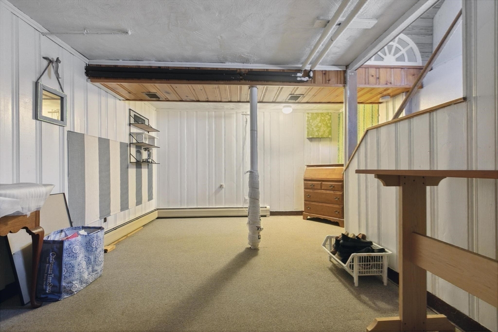 8 Dodge Street Arlington, MA 02474 - Photo 27 of 36 a view of an empty room with wooden floor and windows