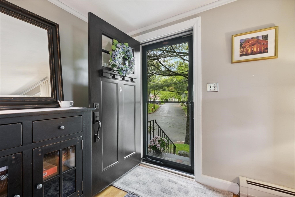 8 Dodge Street Arlington, MA 02474 - Photo 7 of 36 a view of a hallway with wooden floor and a fireplace