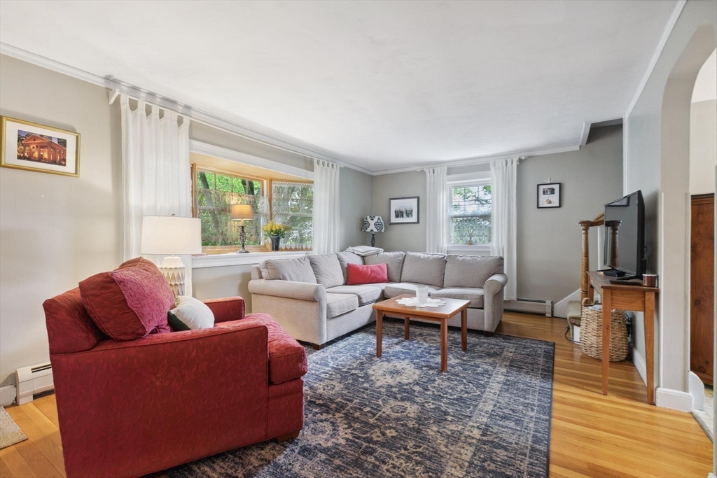8 Dodge Street Arlington, MA 02474 - Photo 10 of 36 a living room with furniture large window and a wooden floor