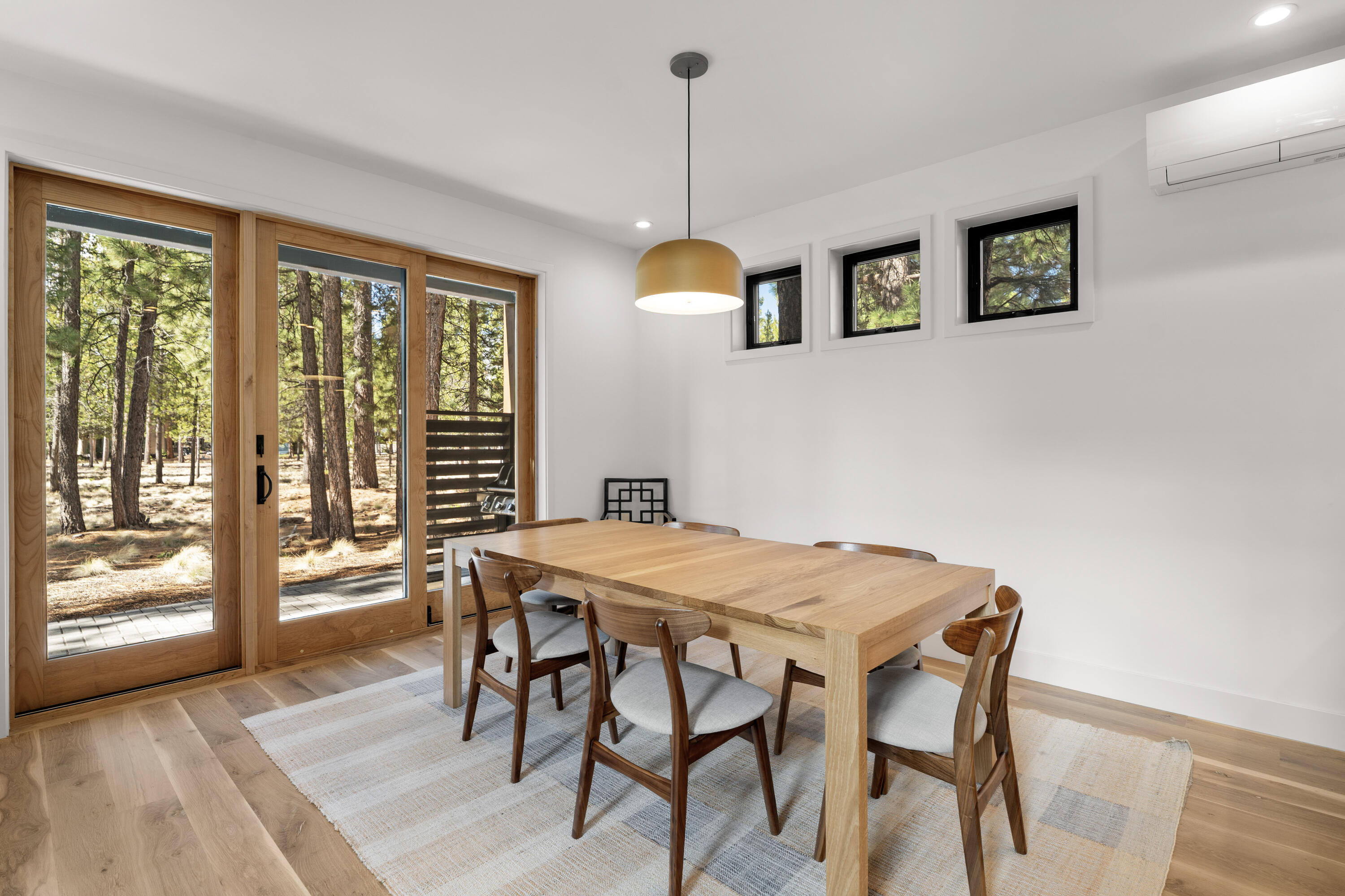 56670 Sunstone Loop, Unit LOT 141 Bend, OR 97707 - Photo 13 of 62 Inviting eating area with broad glass doors, warm wood tones, and an open connection to the kitchen and great room. Bright and comfortable, it is well suited for both daily use and gathering with guests.