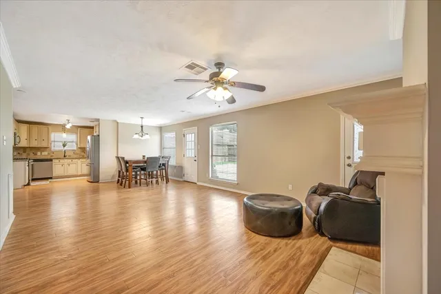a living room with furniture and wooden floor