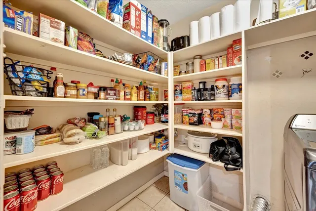 a shelf with cup and plates